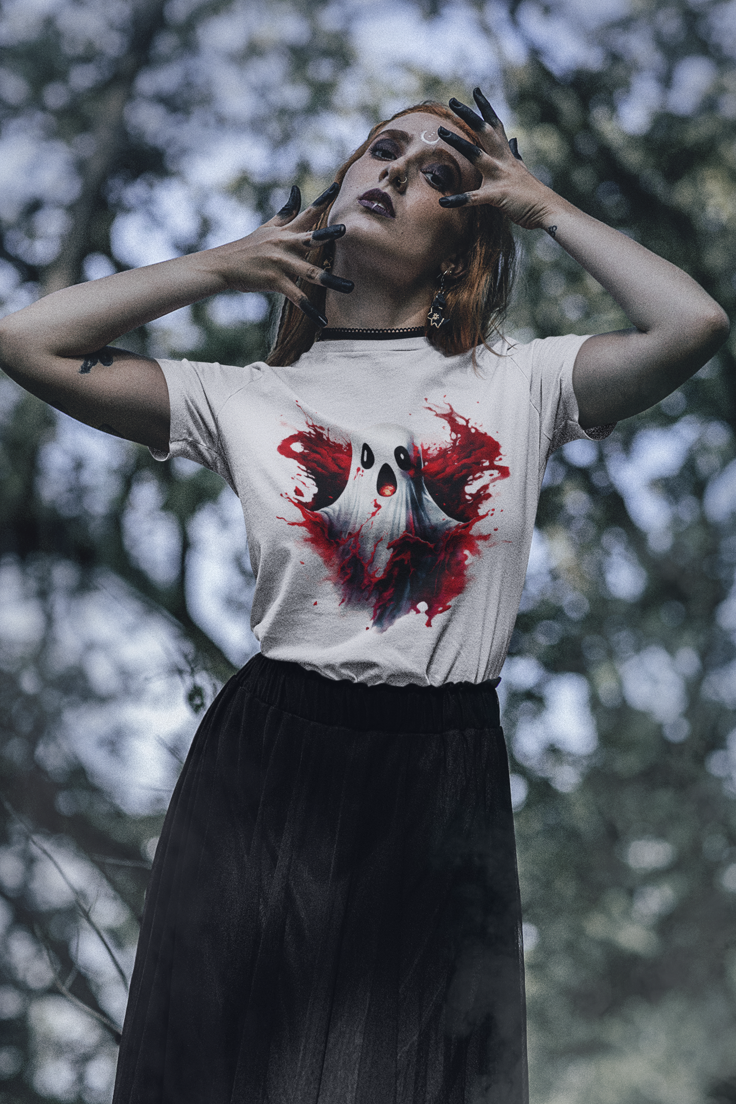 A woman wears a white t-shirt with a bloody ghost design and a black skirt.
