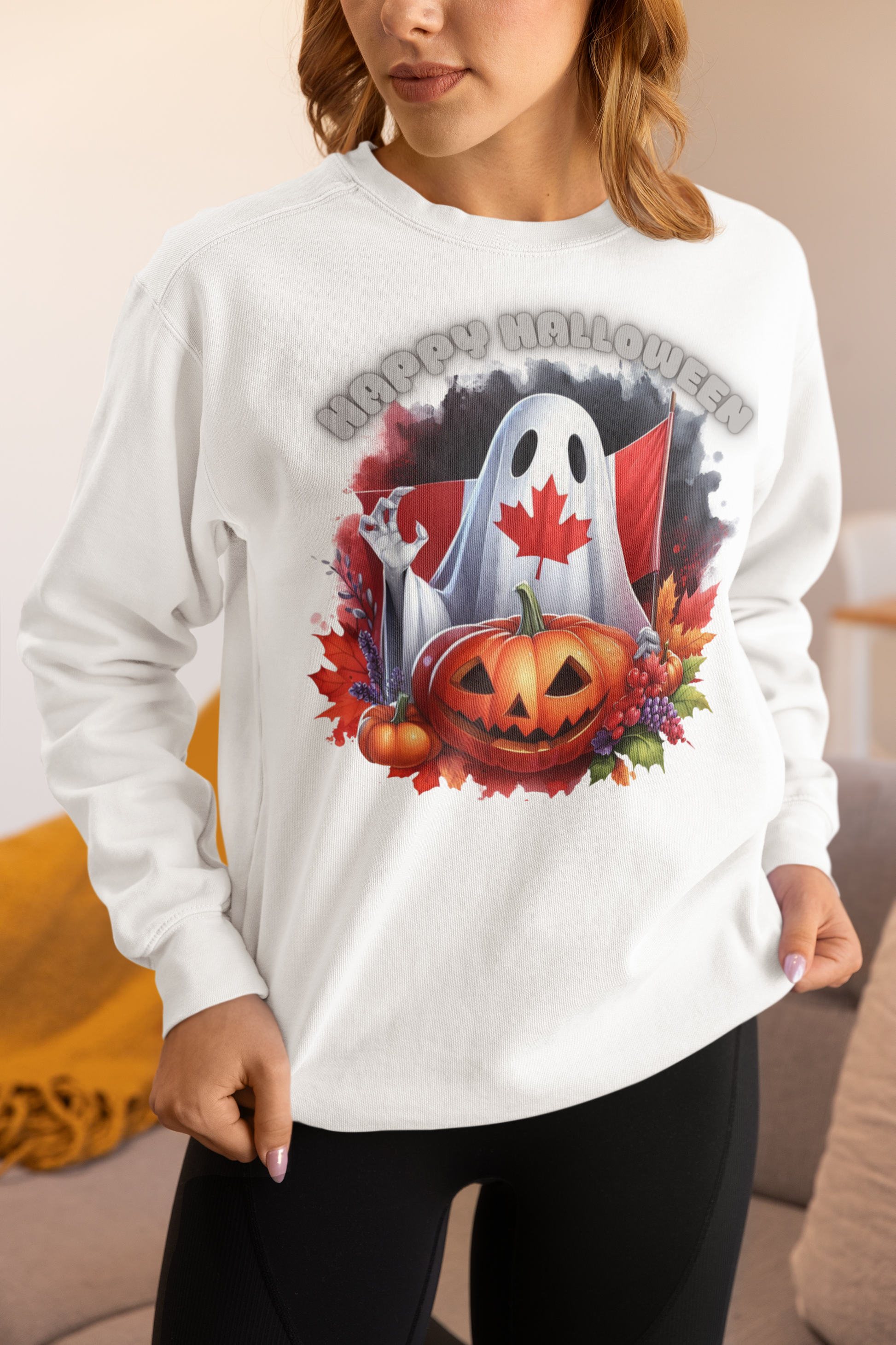 White sweatshirt with a Canadian Halloween ghost and pumpkin design.