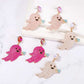 Six pairs of ghost-shaped dangle earrings with synthetic pearls in pink, fuchsia, and white.