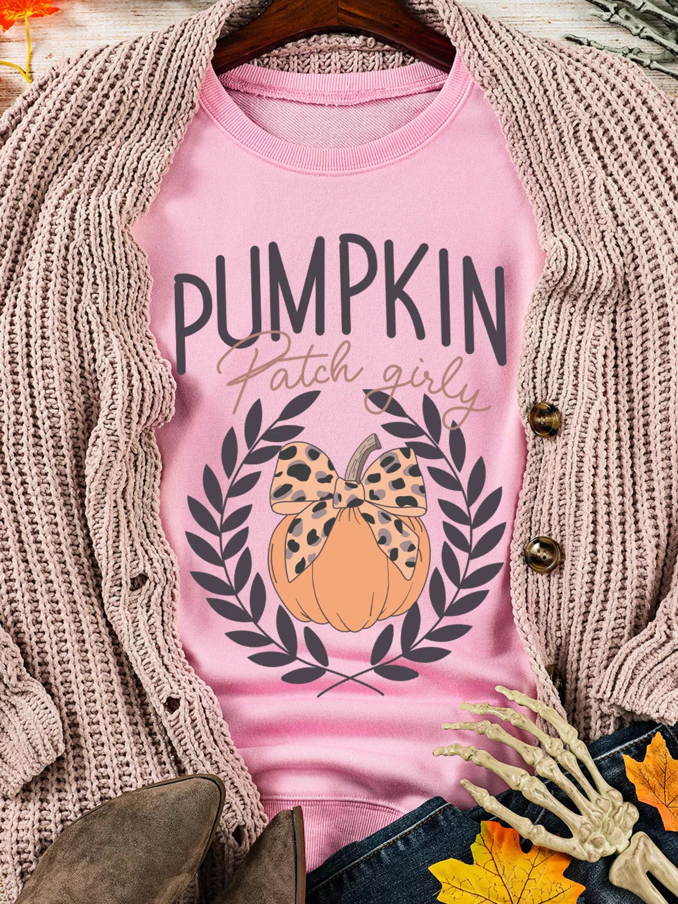 Pink Halloween sweatshirt with a leopard bowknot pumpkin graphic.