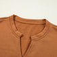 Happy Halloween graphic notched long sleeve loose top in a warm brown color.