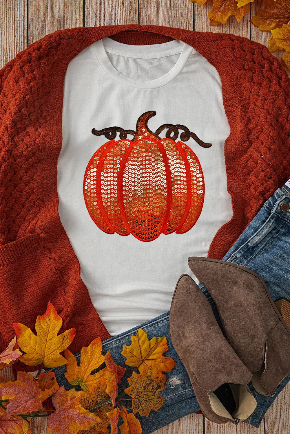 White short sleeve t-shirt with a sequin pumpkin design, paired with a rust cardigan.