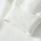 Close-up of a white hoodie sleeve with a ribbed cuff.