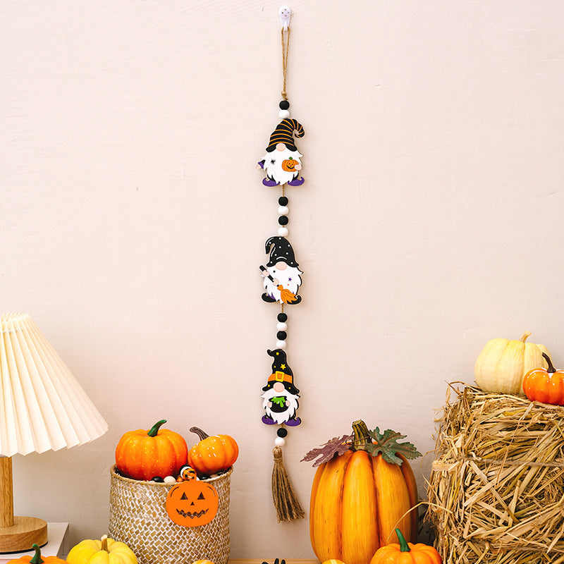 Three Halloween gnome hanging decorations with black and white beads and a tassel.