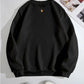 Black round neck sweatshirt with ribbed cuffs and hem.