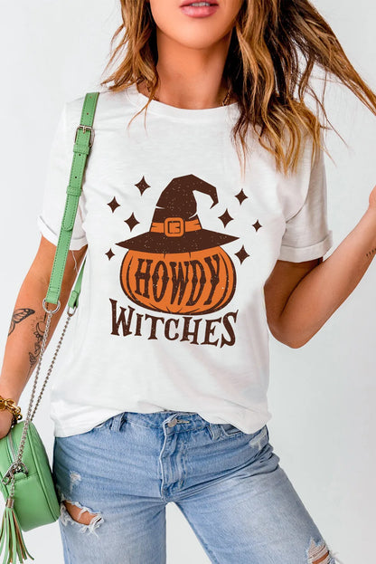 A woman wears a white "HOWDY WITCHES" t-shirt with a pumpkin and witch hat design.