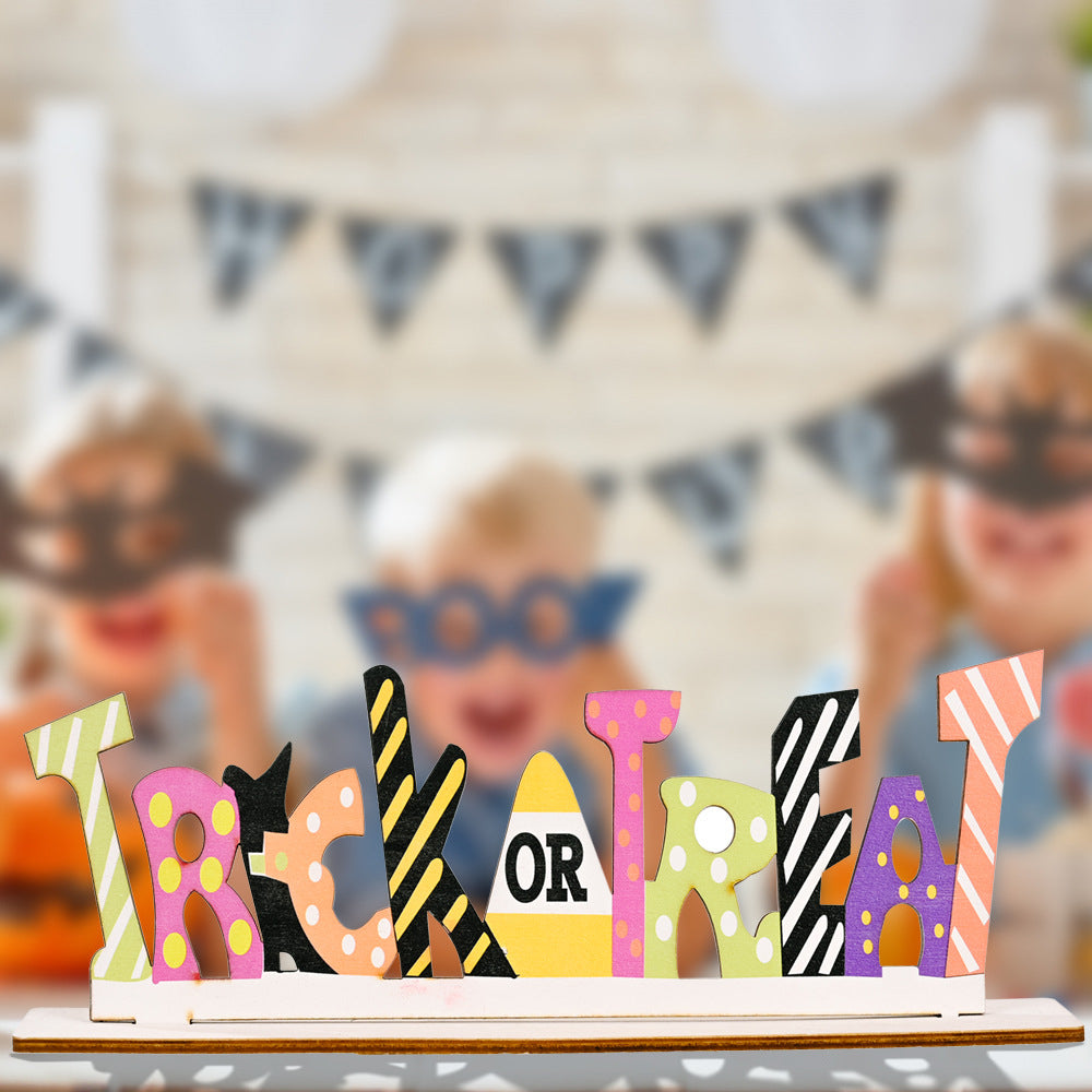 Colorful wooden "Trick or Treat" sign with blurred children and banner in the background.
