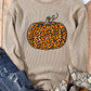 A beige long-sleeve sweatshirt with a leopard print pumpkin design.