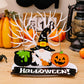 A wooden Halloween decoration featuring a gnome, cauldron, pumpkin, and "HALLOWEEN!" text.