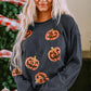 Blonde woman wearing a dark gray sequin pumpkin round neck sweatshirt.