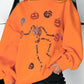 Orange Halloween sweatshirt with a sequin skeleton and pumpkins.