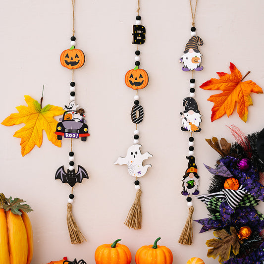 Three Halloween-themed wooden hanging decorations featuring pumpkins, gnomes, and ghosts.