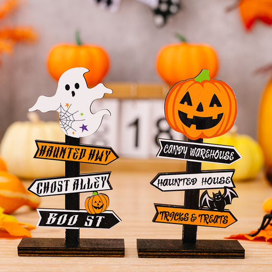 Two wooden Halloween-themed directional signs, one with a ghost and the other with a pumpkin.