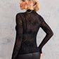 Black sheer long-sleeve blouse with a spider web print.