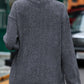 A woman from behind wears a gray long-sleeve sweatshirt with a ribbed texture.