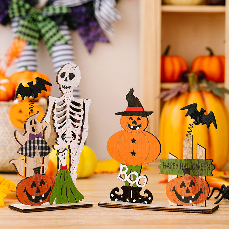 Two wooden Halloween ornaments, one with a skeleton and ghost, the other with a pumpkin.