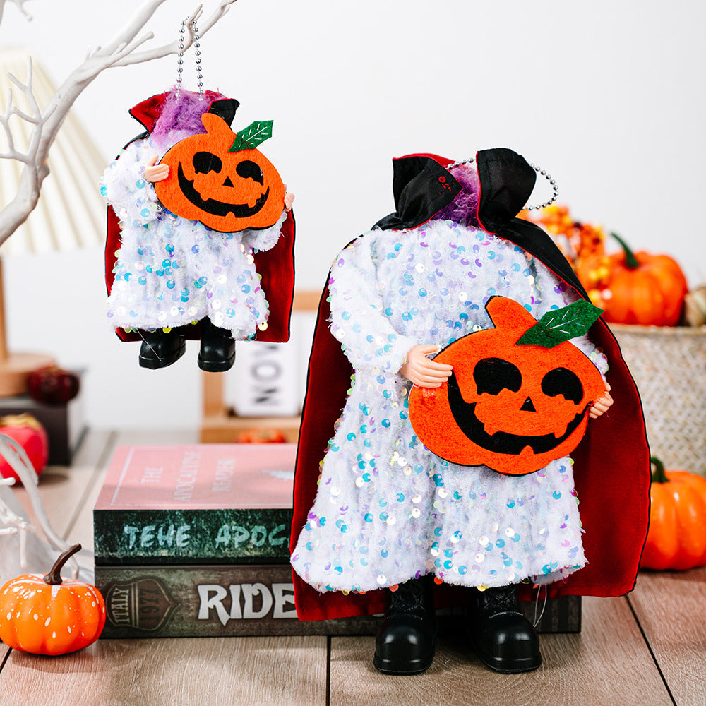 Two sequined Halloween figures with red capes, holding jack-o'-lanterns.