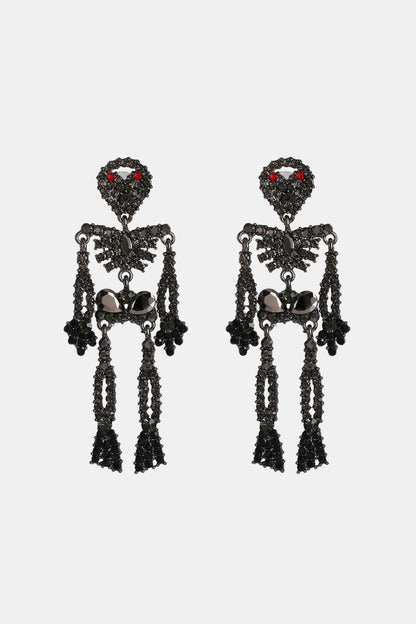 Two black skeleton-shaped dangle earrings with red and black glass stones.
