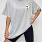 Round neck short sleeve ghost graphic t-shirt worn with black shorts.