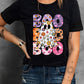 A woman wears a black short-sleeve t-shirt with a colorful "BOO" ghost graphic.