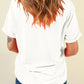 Back view of a woman wearing a white short-sleeve t-shirt and blue jeans.