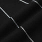 Black flared jeans with white spider web embroidery.