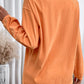 Orange ribbed long-sleeve sweatshirt with a round neck.