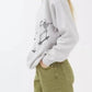 Oversized sweatshirt with a skeleton graphic, paired with olive green shorts.
