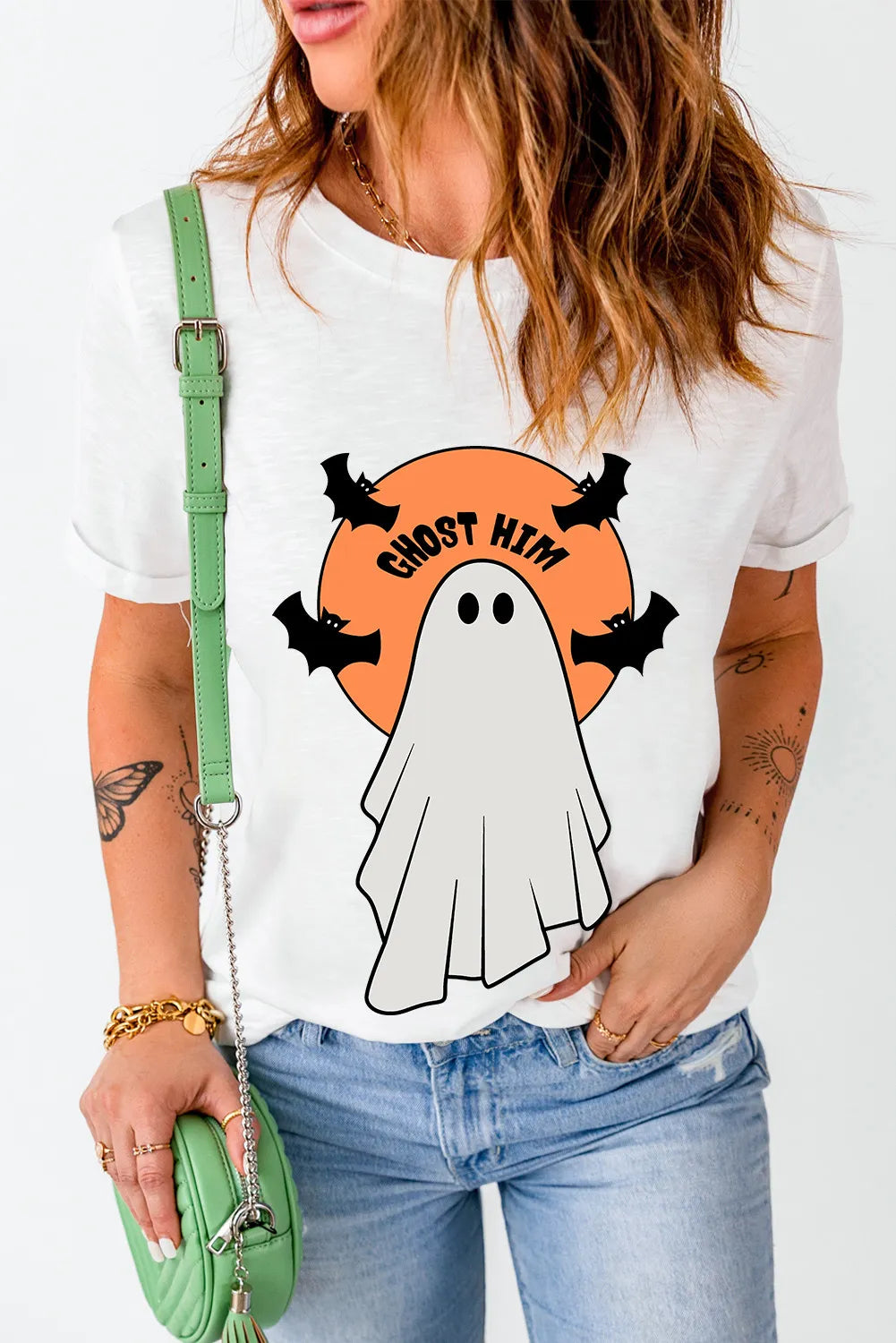 A woman wears a white short-sleeve t-shirt with a "Ghost Him" graphic.