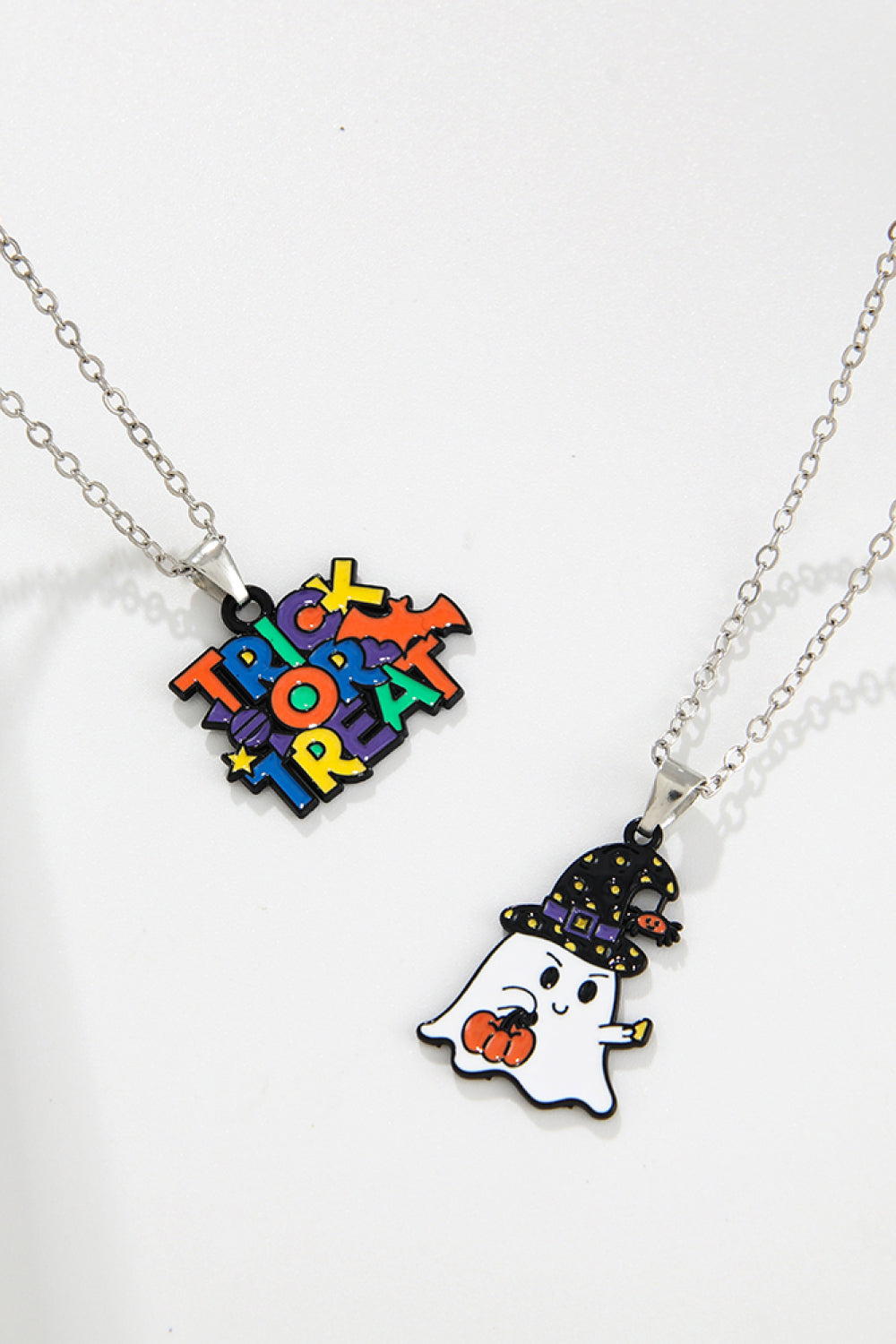 Two Halloween-themed necklaces, one with "Trick or Treat" and one with a ghost.