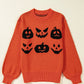 An orange round neck sweater features six black pumpkin faces.