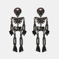Two black skeleton-shaped dangle earrings with red and black glass stones.