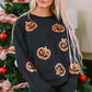 Sequin patch pumpkin round neck sweatshirt on a woman in front of a Christmas tree.