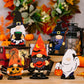 Six wooden Halloween gnome and ghost ornaments are displayed on a wooden surface.
