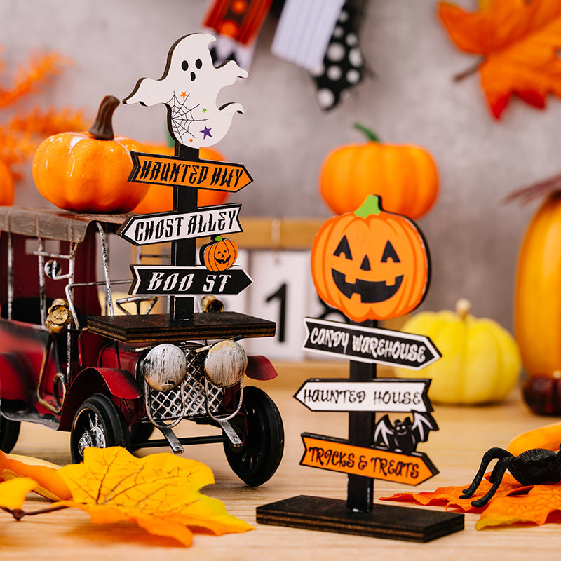 Two wooden Halloween signs, one with a ghost and the other with a jack-o'-lantern.