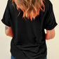 A woman from behind wears a black short-sleeve t-shirt and blue jeans.