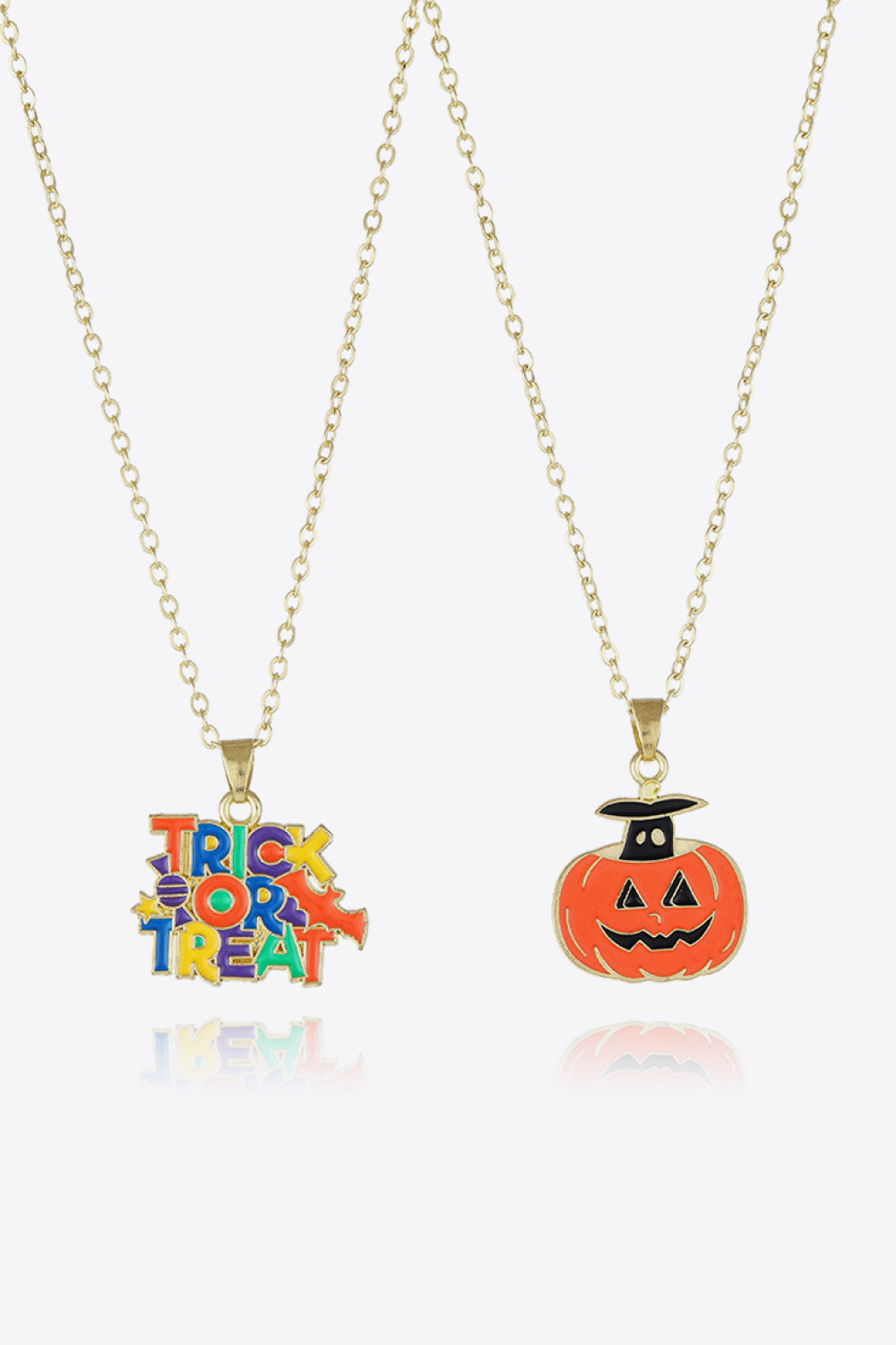 Two gold-tone necklaces, one with a colorful "Trick or Treat" pendant and one with a jack-o'-lantern.