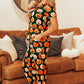 A woman models a pumpkin-printed short sleeve top and pants lounge set.
