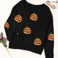 Black knit top with sequin pumpkins and a round neck.