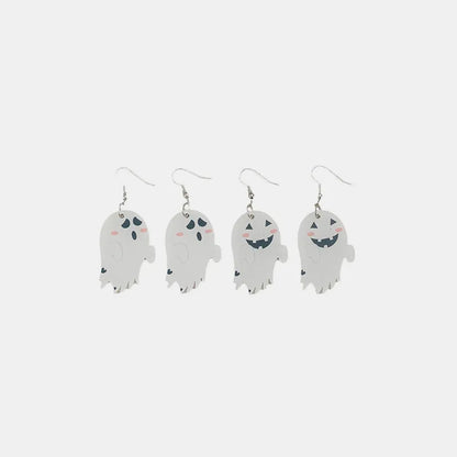 Two pairs of white ghost dangle earrings, one pair with simple faces, the other with smiling jack-o'-lantern faces.