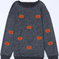 A gray long-sleeve sweatshirt with a round neck and multiple pumpkin appliques.