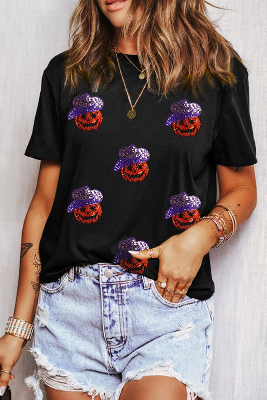 Black short-sleeve t-shirt with sequin pumpkins wearing purple hats.
