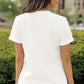 White short-sleeve t-shirt with a round neck, worn by a woman facing away.