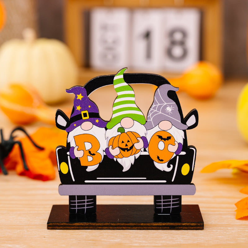 Three Halloween gnome ornaments in a car-shaped design, spelling "BOO".
