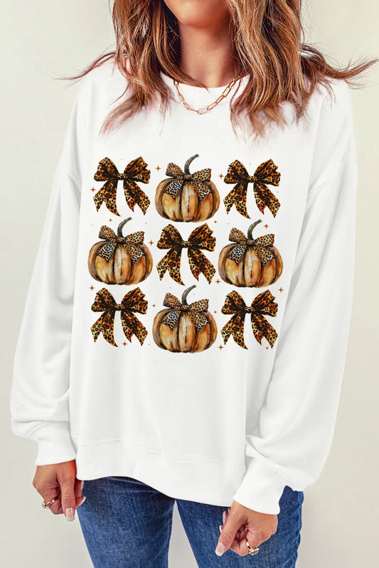 White long-sleeve sweatshirt with nine leopard print pumpkins and bows.