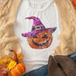 White short-sleeve t-shirt with a sequin pumpkin wearing a witch hat.