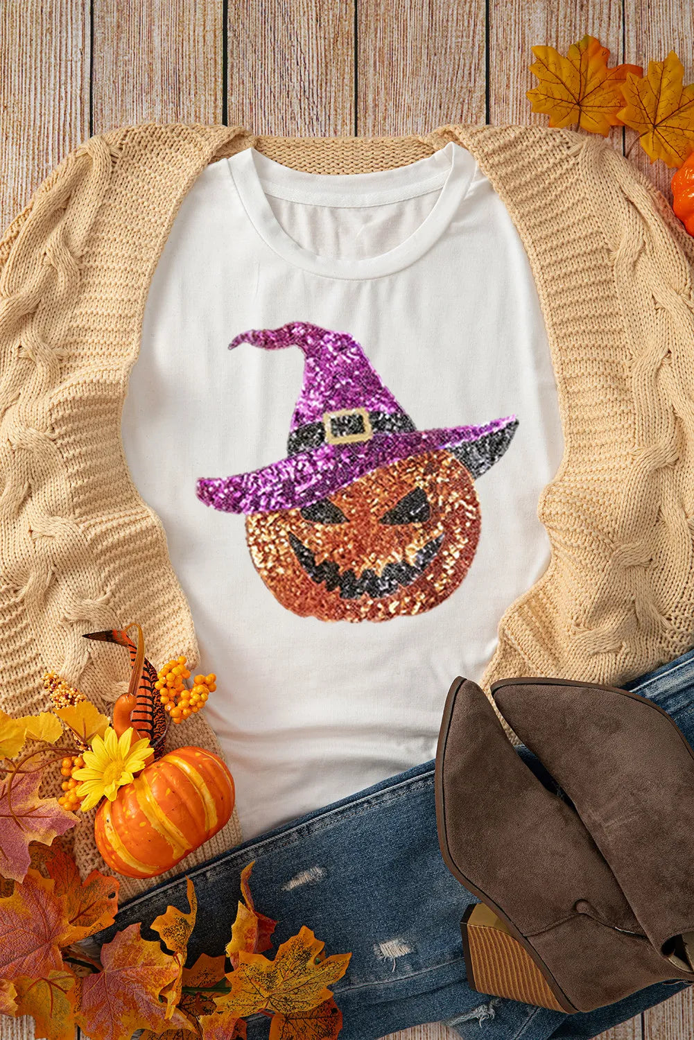 White short-sleeve t-shirt with a sequin pumpkin wearing a witch hat.