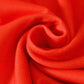 Close-up of a vibrant red fabric with soft folds and subtle texture.