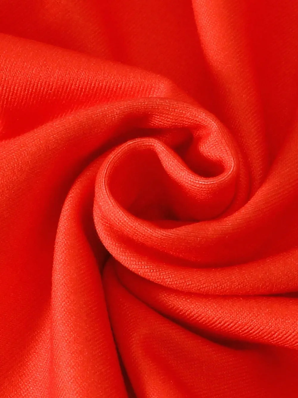 Close-up of a vibrant red fabric with soft folds and subtle texture.