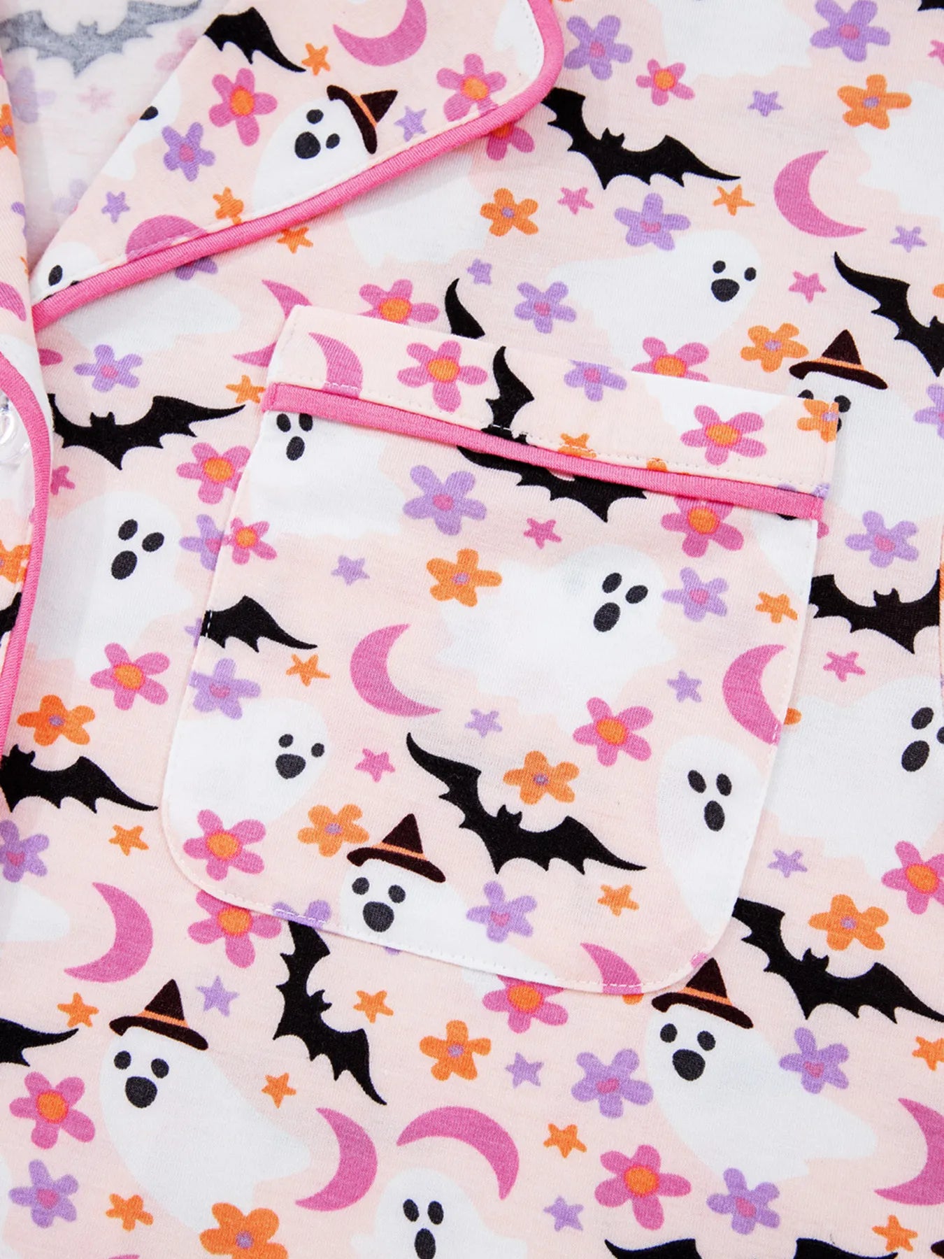 Pink button-up top with a Halloween ghost, bat, and flower print.